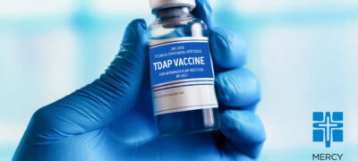 hand holding tdap vaccine