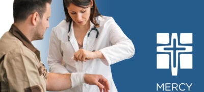 Photo of a practitioner wrapping a man's wrist with gauze